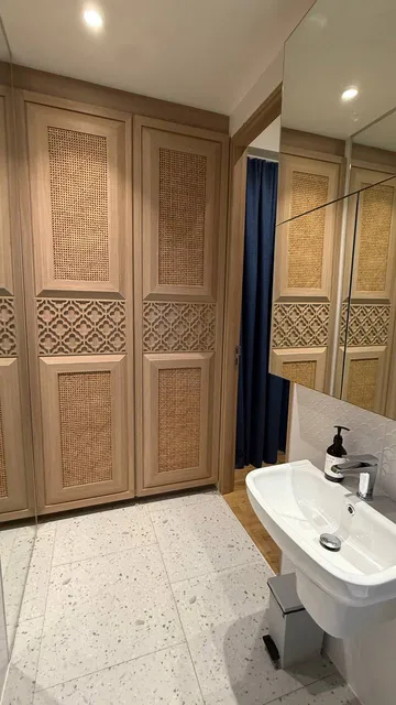 Bedroom 3: built-in wardrobes and washbasin