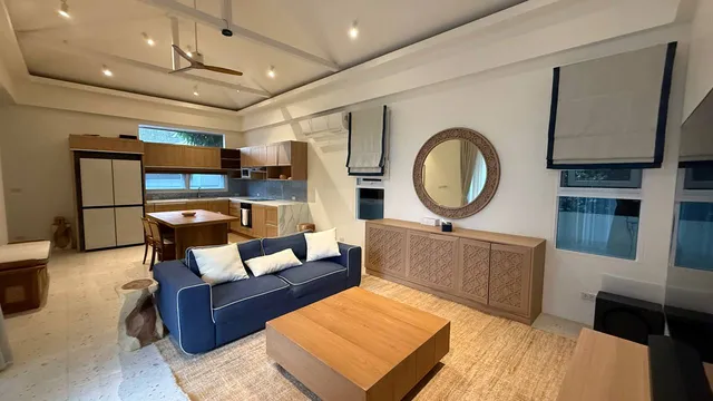 The living room with the kitchen behind it